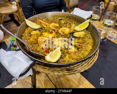 Freshly cooked Paella server on a table in a resturant in spain Stock Photo