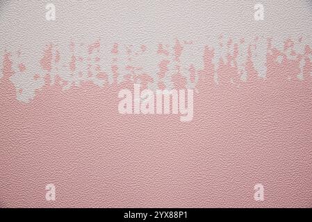 A wall with a pink and white stripe. The wall is covered in a textured material Stock Photo