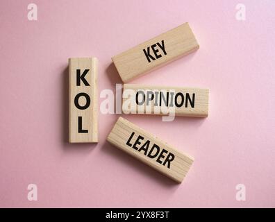 KOL - Key Opinion Leader symbol. Concept word KOL on wooden blocks. Beautiful pink background. Business and KOL concept. Copy space. Stock Photo