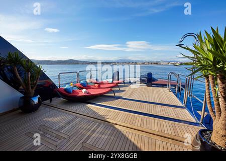 Luxurious Superyacht Swimming Deck with Stylish Furniture and Ski boat Overlooking Peaceful Sea Views Stock Photo