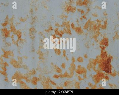 fragment of light metal surface with bright orange abstract rust streaks, texture of aged iron in gray-rusty tones with empty copy space Stock Photo