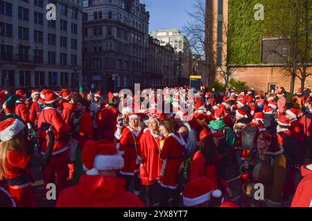 London, UK. 14th Dec, 2024. Revelers gather outside The Black Friar pub in Blackfriars during the SantaCon. Every year, hundreds of revelers dressed as Santa Claus go on a pub crawl in Central London celebrating Christmas. Credit: SOPA Images Limited/Alamy Live News Stock Photo