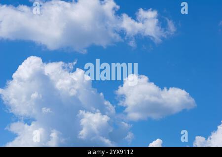 The sky is blue and filled with clouds. The clouds are scattered throughout the sky, with some being larger and others smaller. Scene is peaceful and Stock Photo
