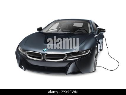 Black 2016 BMW i8 plug-in hybrid electric luxury sports car with charging cord isolated on white background with clipping path Stock Photo