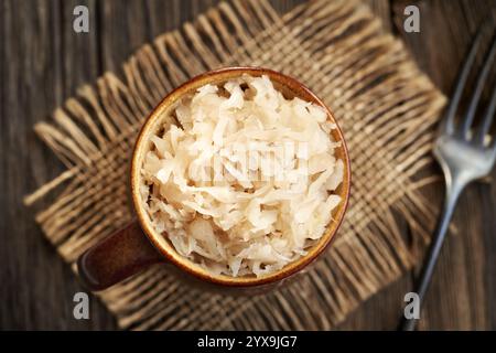 Fermented cabbage or sauerkraut in a pot, top view Stock Photo
