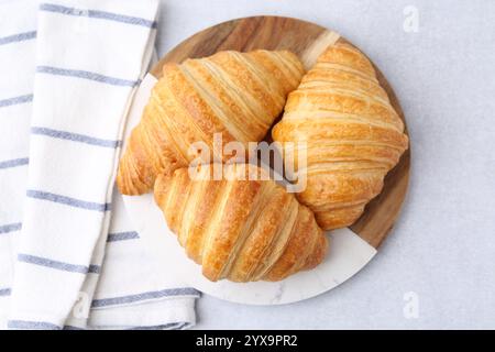 Tasty fresh croissants on light grey table, top view Stock Photo