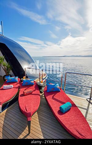 Sun Loungers on a Luxury superyacht swimming platform Overlooking Calm Ocean Waters Stock Photo