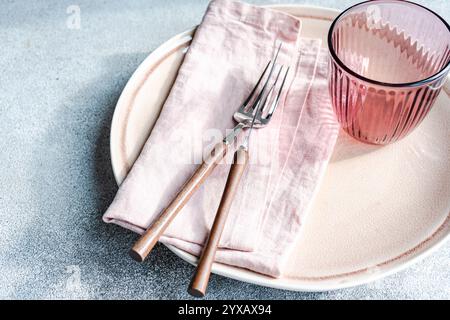 Close-up of a simple pink place setting on a grey background Stock Photo