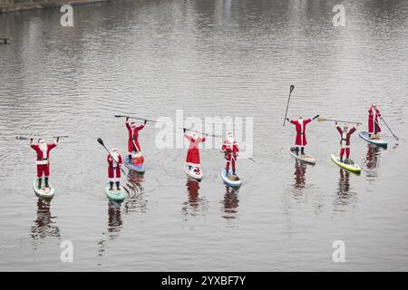 Water sports enthusiasts dressed as Santas ride SUPs on the Spree in Berlin on 14 December 2024 Stock Photo