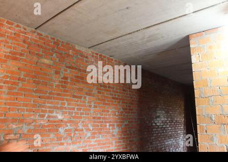 brick wall in the room. Wall joints in an unfinished building room. Stock Photo