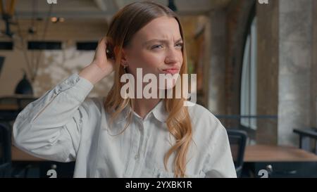 Business financial data work in office confused Caucasian girl analyze diagrams documents businesswoman female business woman scratching head Stock Photo
