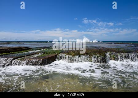 Ocean waves breaking over rocks Stock Photo