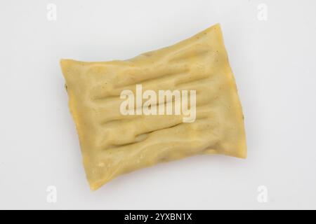 Single Maultasche (South German Ravioli) Specialty on White Background Stock Photo