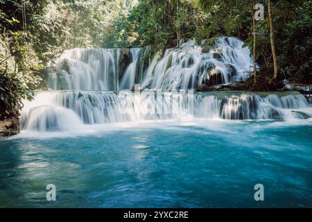 Scenic cascade waterfall with blue water in tropical jungle Stock Photo