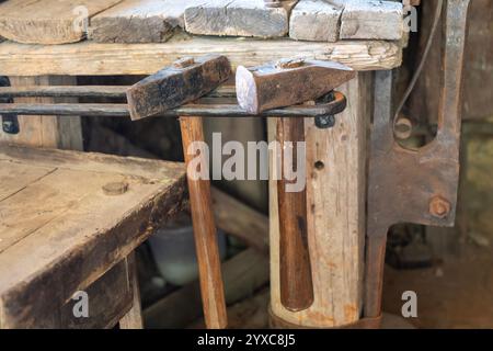 Blacksmith hammers on a wooden workbench in an old workshop Stock Photo