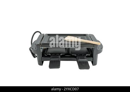 Electric raclette grill used to prepare processed cheese. Isolated on a white background. Stock Photo