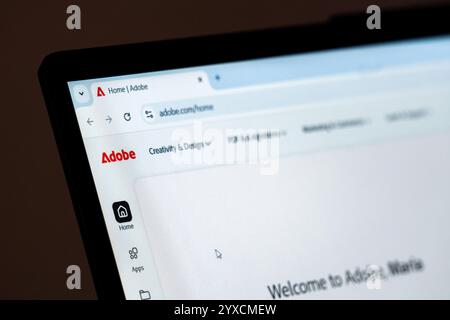 New York, USA - December 15, 2024: Adobe website homepage displayed on computer screen with visible logo. Online platform for creative software Stock Photo