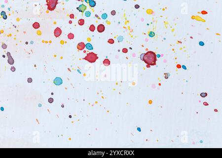 Macro close-up of colorful watercolor splashes, splatters and stains on white paper. Abstract high resolution full frame textured background. Stock Photo