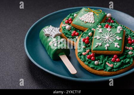 Natural popsicle ice cream on a stick covered with chocolate in the style and colors of Christmas and New Year on a dark concrete background Stock Photo