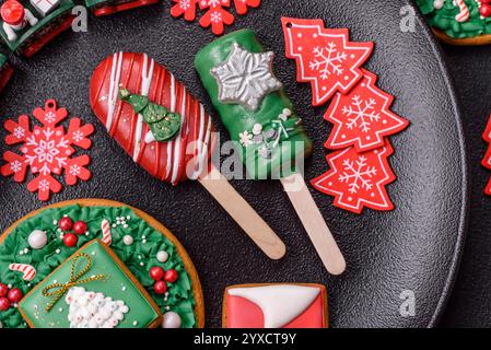Natural popsicle ice cream on a stick covered with chocolate in the style and colors of Christmas and New Year on a dark concrete background Stock Photo