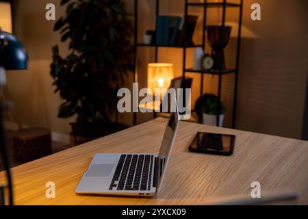 Create a Cozy Home Office Setup Featuring a Laptop and Tablet for Productive Work Days Stock Photo