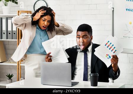 Stressed African American colleagues missing project deadline at office Stock Photo