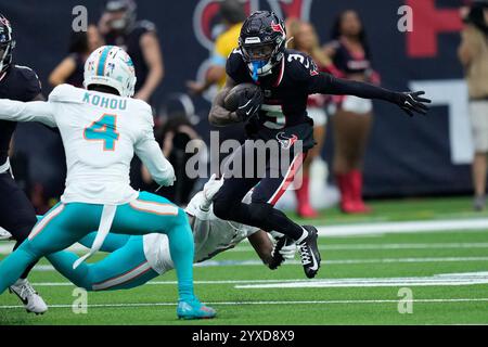 Houston, Texas on Sunday, December 15, 2024. Houston Texans wide receiver Tank Dell (3) gets away from Miami Dolphins cornerback Kader Kohou (4) and safety Jevon Holland (8) for a first down during the first quarter at NRG Stadium in Houston, Texas on Sunday, December 15, 2024. Photo by Kevin M. Cox/UPI Credit: UPI/Alamy Live News Stock Photo