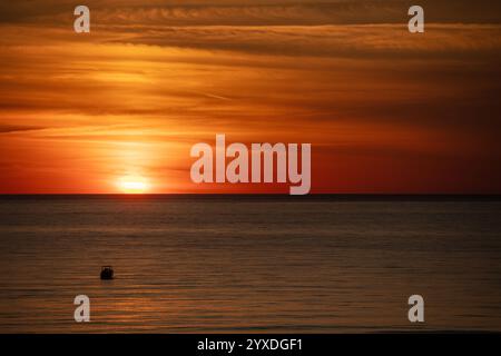 Sunset (or sundown) with a boat at Marco Island, Gulf of Mexico, Florida Stock Photo