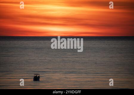 Sunset (or sundown) with a boat at Marco Island, Gulf of Mexico, Florida Stock Photo