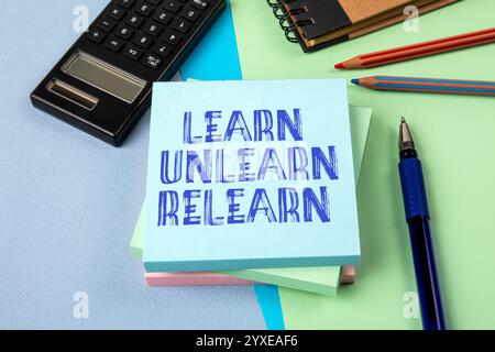 Learn Unlearn Relearn Concept. Notepad with text on office table. Stock Photo
