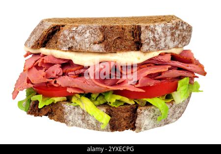 Pastrami and salad sandwich in sliced German style crusty sourdough rye bread with mayonnaise isolated on a white, background Stock Photo