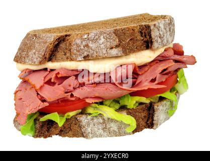 Pastrami and salad sandwich in sliced German style crusty sourdough rye bread with mayonnaise isolated on a white, background Stock Photo