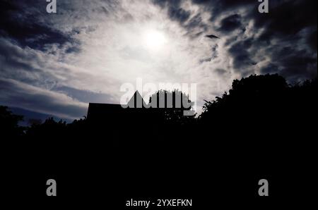 Cottage roof at night under the moonlight Stock Photo