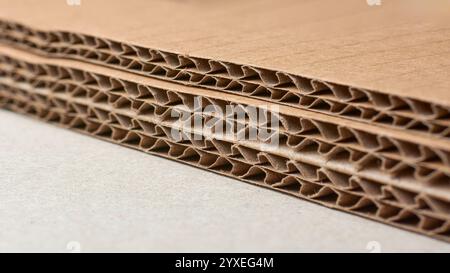 close-up of corrugated cardboard sheets edges, visible multiple wavy inner layer structure pattern, made of recycled paper Stock Photo