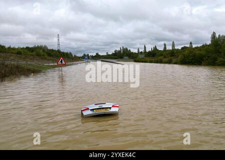PA REVIEW OF THE YEAR 2024 File photo dated 24/09/24: The open boot of a car is visible above the water where the vehicle is submerged in flood water on a421 in Marston Moretaine, Bedfordshire. Parts of Britain have been struck by flash floods after some areas saw more than a month's worth of rain in 24 hours. Issue date: Monday December 16, 2024. Stock Photo