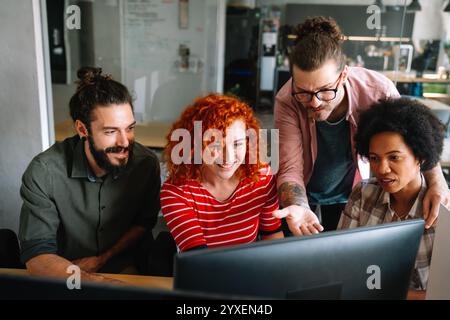 Mixed team of software engineers brainstorming ideas. Diverse app developers collaborating as group Stock Photo