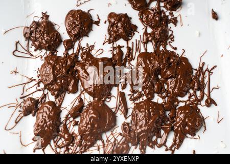 Textured background: Splashes of milk dark chocolate on a white plate or background. High quality photo Stock Photo