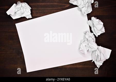 Blank white paper with crumpled balled up paper on office desk, mockup copy space Stock Photo