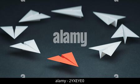 Group of paper planes in one direction and with one individual pointing ...