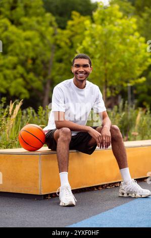 Sportsman sitting on a bench and resting after the game Stock Photo