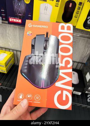Kyiv, Ukraine - December 15, 2024: A close-up of a gaming mouse box with detailed RGB lighting designs. Features high-resolution specs and additional Stock Photo