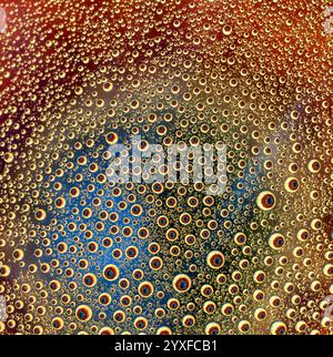 Water droplets against a colourful flower background Stock Photo
