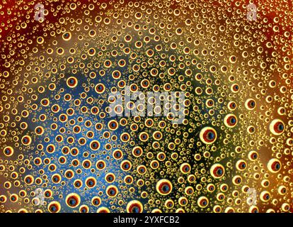 Water droplets against a colourful flower background Stock Photo