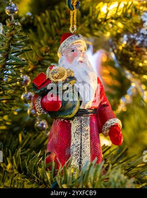 A Christmas tree decoration in the form of Santa Claus, hanging on a Christmas tree Stock Photo