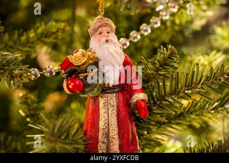 A Christmas tree decoration in the form of Santa Claus, hanging on a Christmas tree Stock Photo