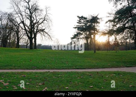 Exploring the tranquil beauty of Bois de Vincennes park in Paris during sunset Stock Photo
