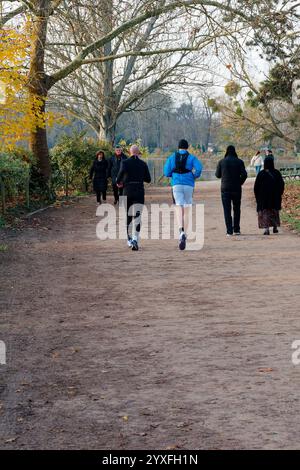 People jogging and walking in Bois de Vincennes park in Paris during a sunny day in autumn Stock Photo