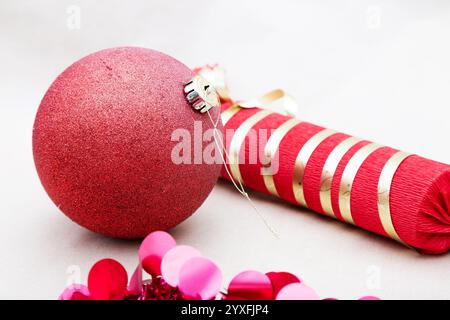 There is a red ball positioned right next to a red and gold striped napkin Stock Photo