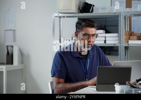 Portrait of Man Working in Office with Laptop Computer Stock Photo