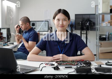 Portrait of Woman Smiling in Technology Lab Setting Stock Photo